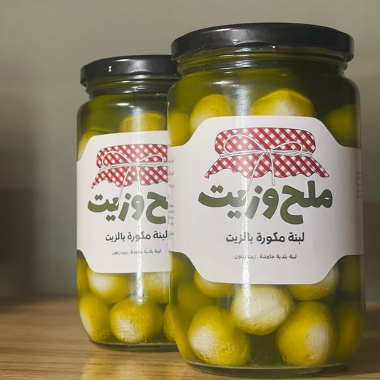 مجموعة من المرطبانات الزجاجية تحتوي على لبنة مكورة بزيت الزيتون